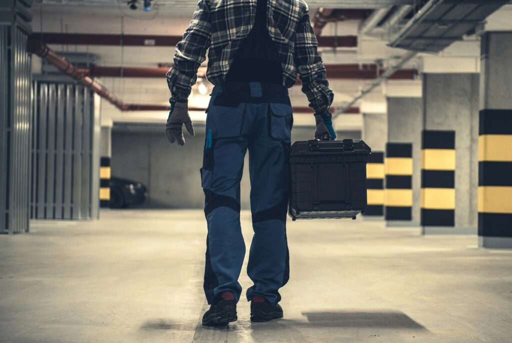 Technician Worker with Large Tools Box in Hands